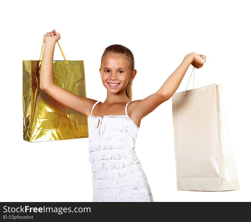 Pretty teenage girl with shopping bags in studio against white background