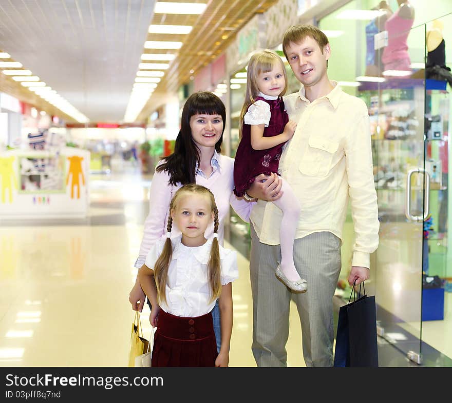 Young family with shopping bags doing shopping. Young family with shopping bags doing shopping