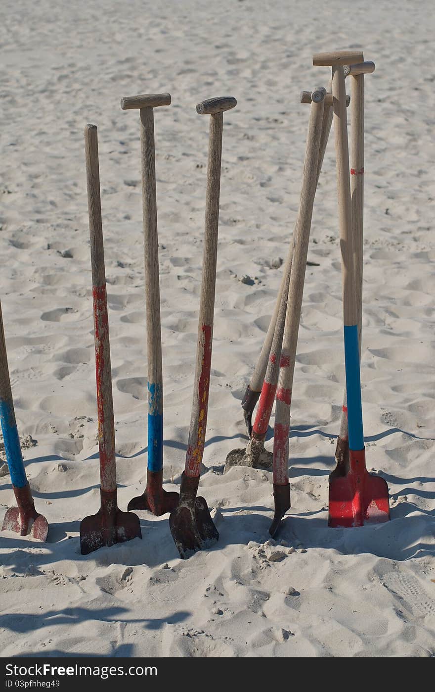 Some spades sticking in the sand. Some spades sticking in the sand