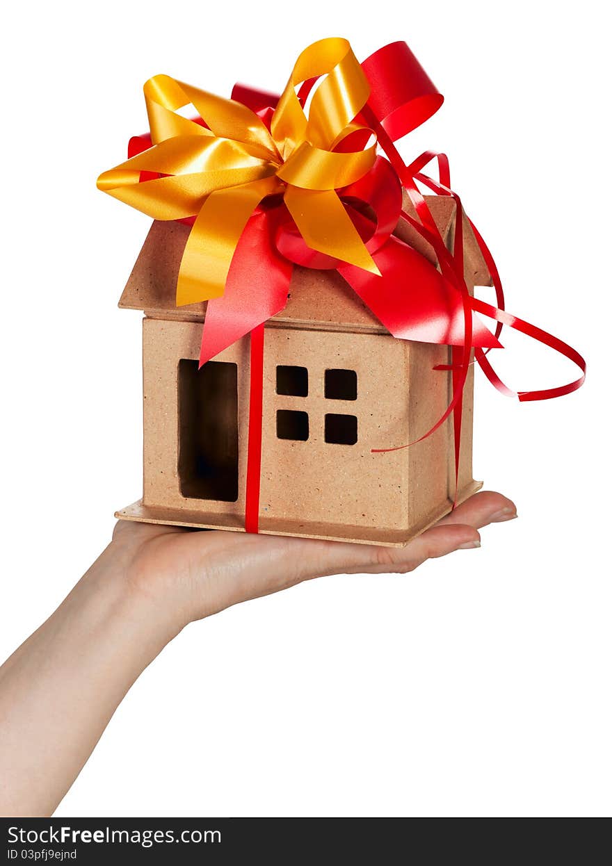 Miniature model concept house resting on a female hand, Isolated On White. Miniature model concept house resting on a female hand, Isolated On White