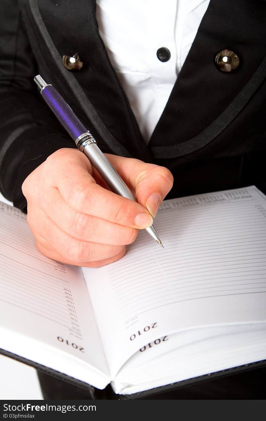 A businesswoman writing in her diary