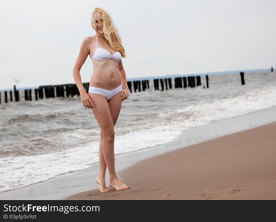 Young beautiful woman at the beach. Young beautiful woman at the beach