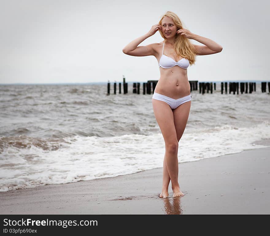 Young beautiful woman at the beach. Young beautiful woman at the beach