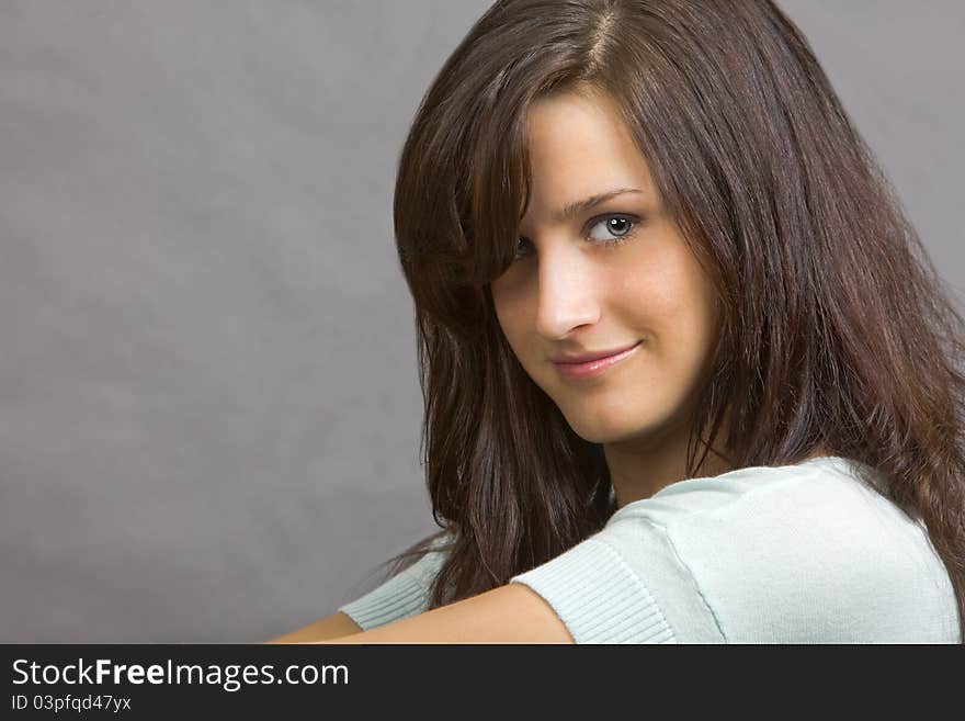 An attractive young brunette woman with a smile