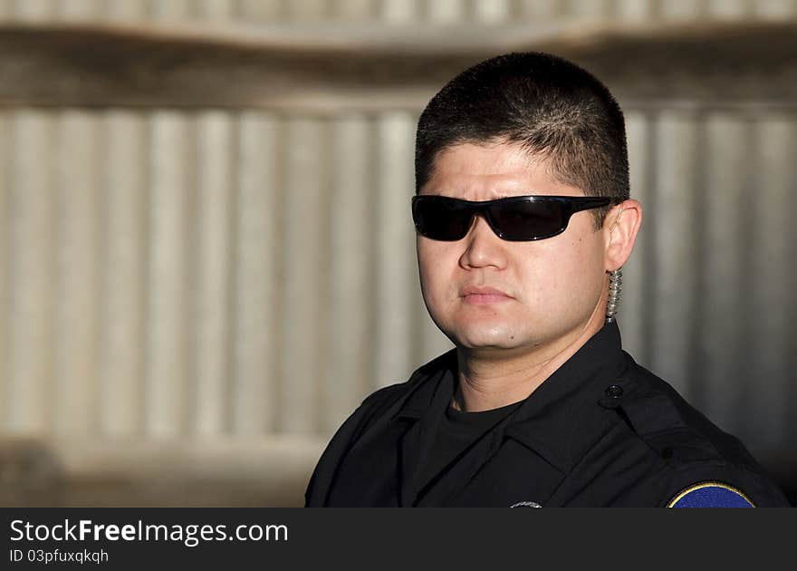 A police officer with a serious look on his face.