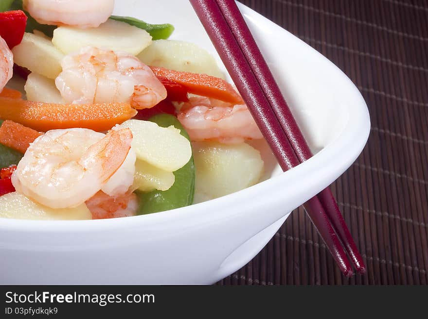 Asian salad in a white bowl with red chopsticks. Asian salad in a white bowl with red chopsticks.