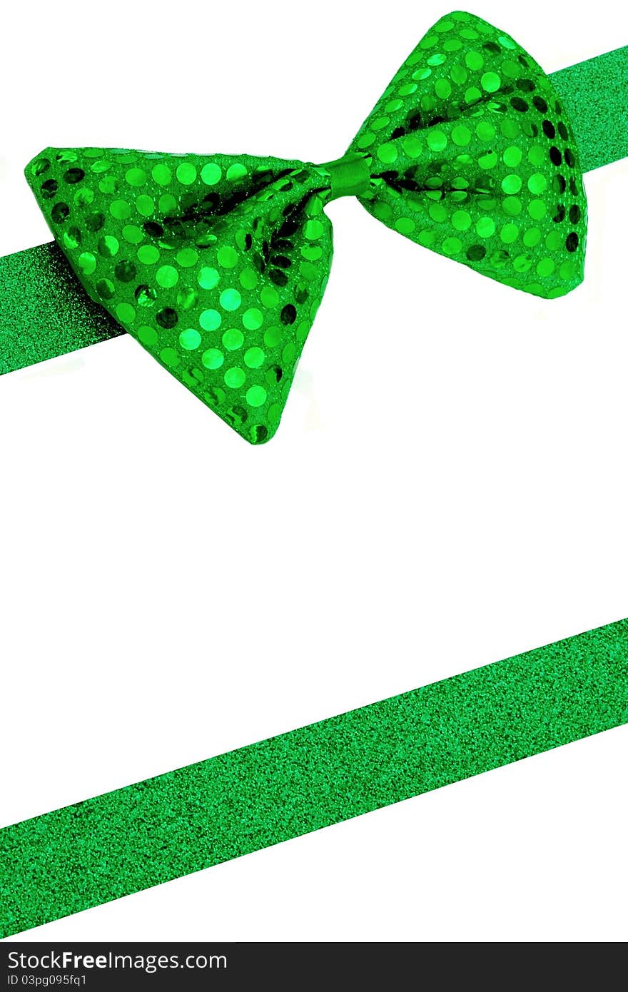 Background image with green bowtie and sparkly ribbon. Ribbon is cut and shaped from sparkly construction paper. Background image with green bowtie and sparkly ribbon. Ribbon is cut and shaped from sparkly construction paper.