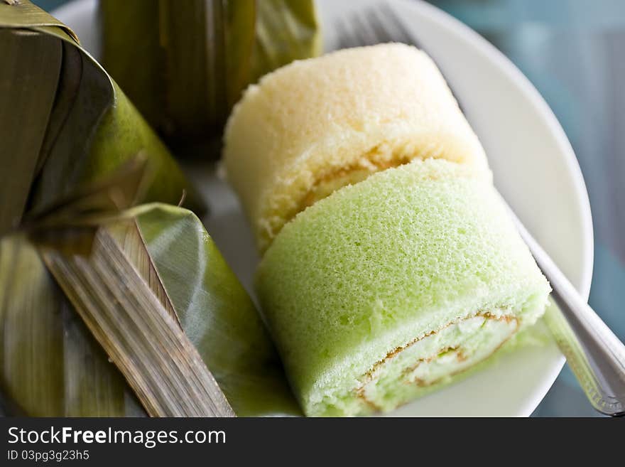 Thai desserts wrapped in banana leaves and steamed cooked with Bun stuffed with cream