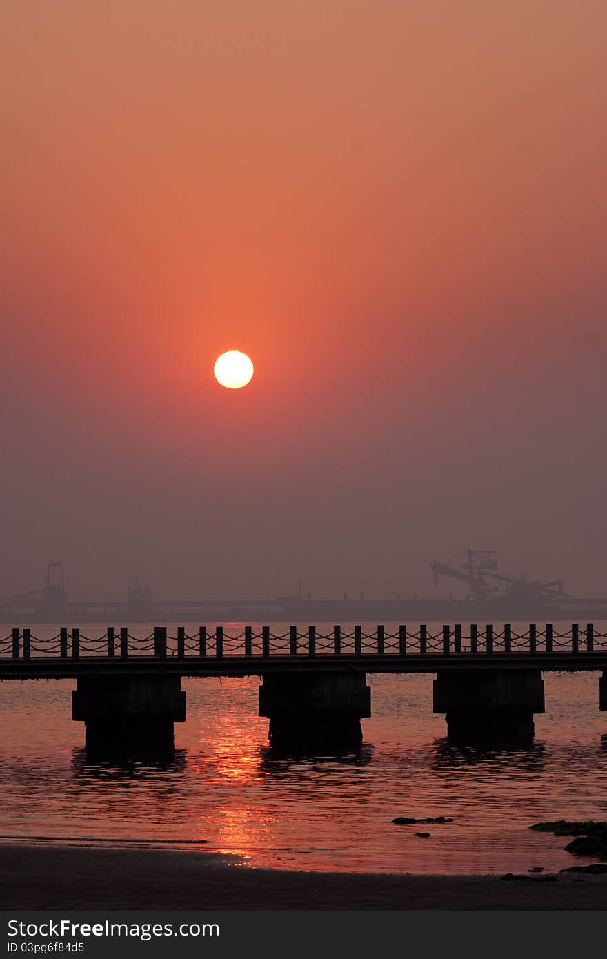 Sunrise Beach, prospect is a bridge, the background is a crane