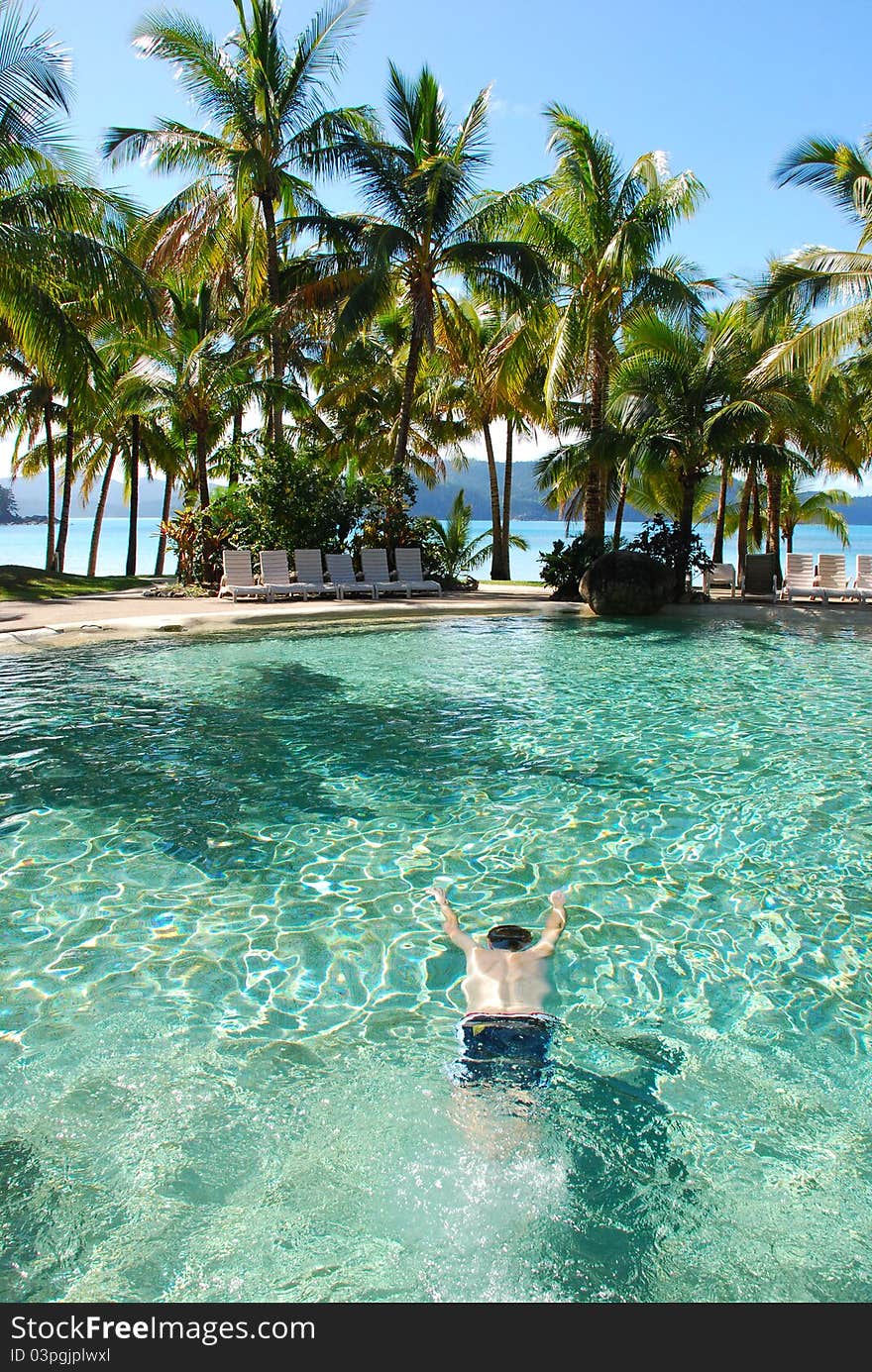 Man swimming under water in pool