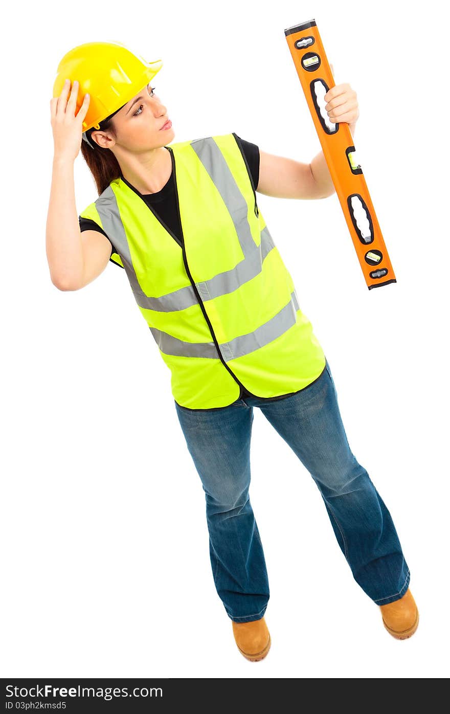 A females dressed in a high visibility jacket holding a spirit level on isloated white background. A females dressed in a high visibility jacket holding a spirit level on isloated white background