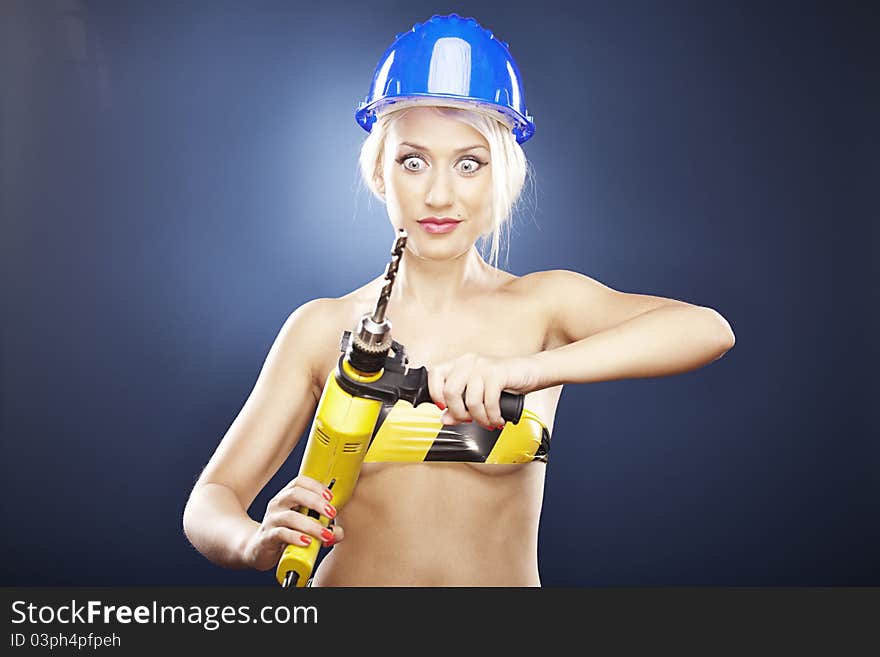 Surprised Girl With Power Drill And Helmet