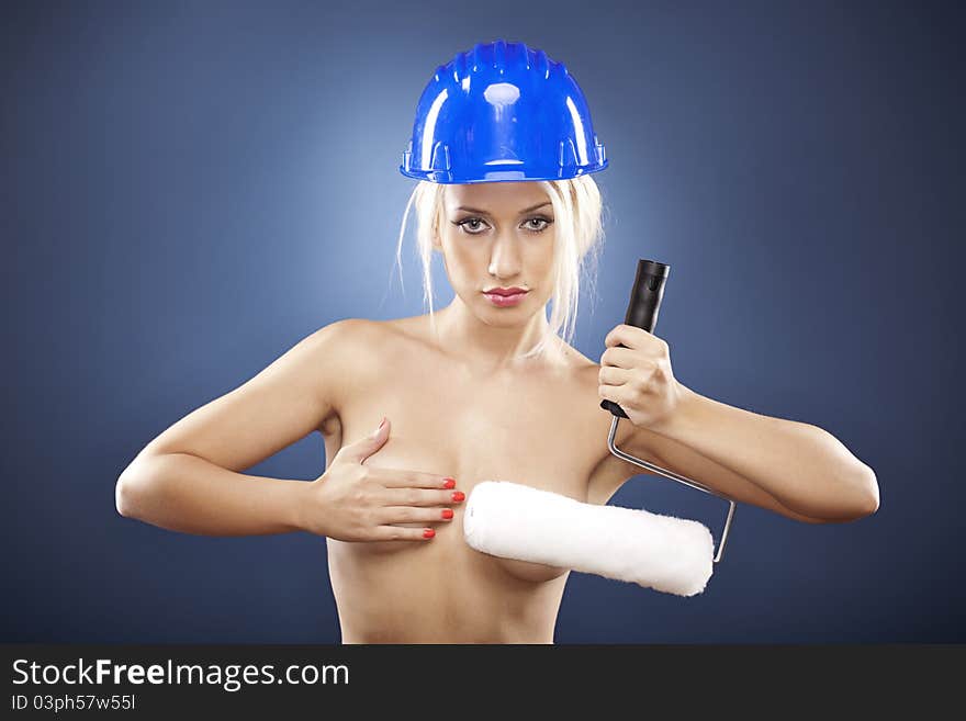 Topless model holding a roller brush.