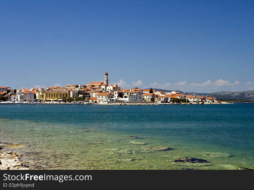 View to Betina architecture, stone houses, church and the coast. View to Betina architecture, stone houses, church and the coast