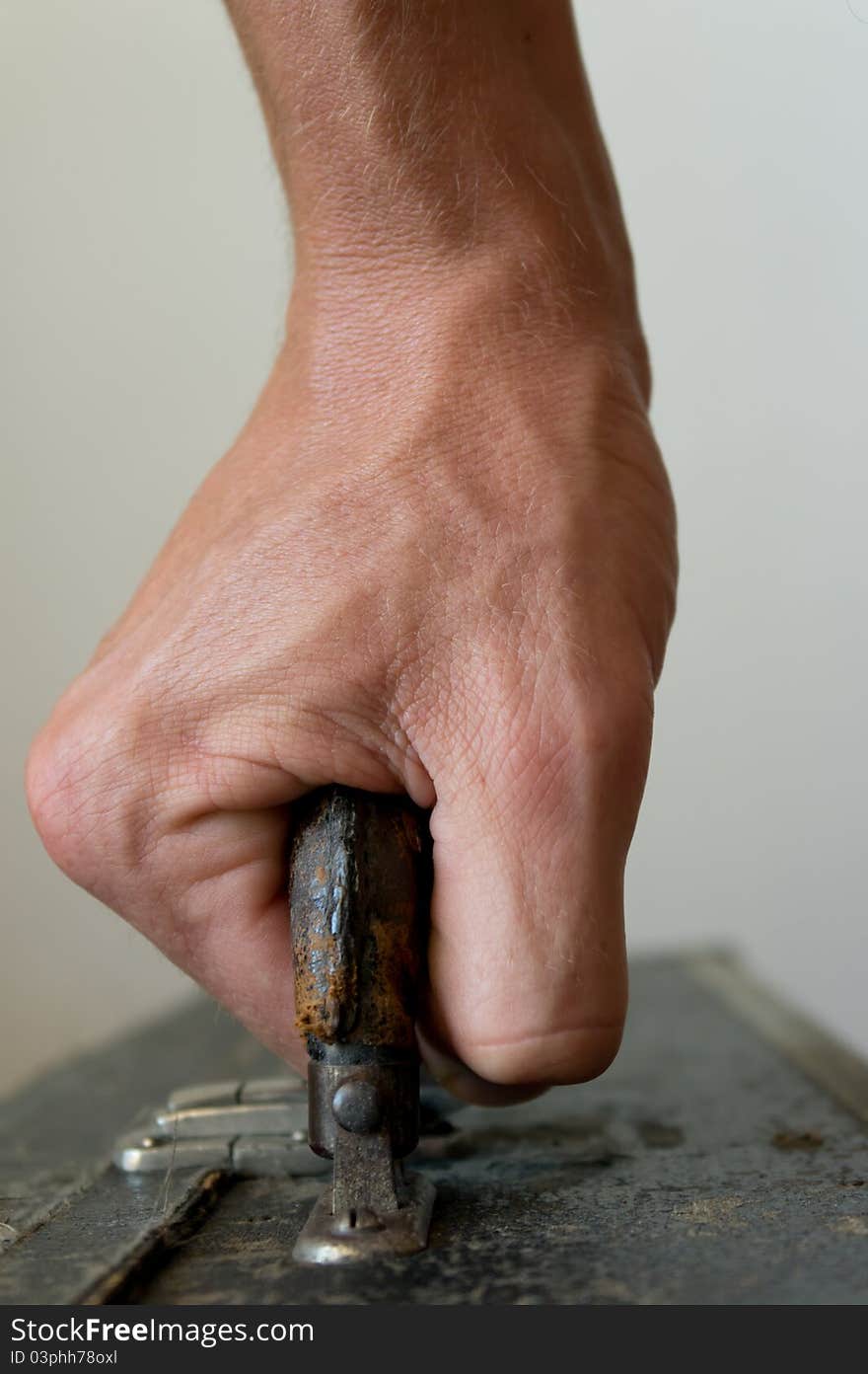 A close-up frontview of a hand, carrying a case. A close-up frontview of a hand, carrying a case