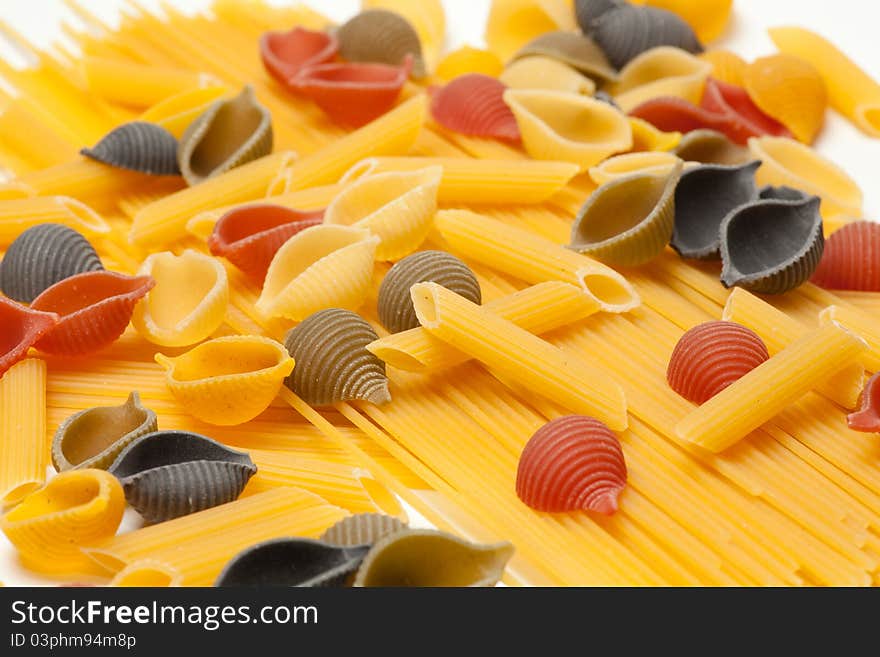 Colorful pasta lying on a bed of spaghtti. Colorful pasta lying on a bed of spaghtti