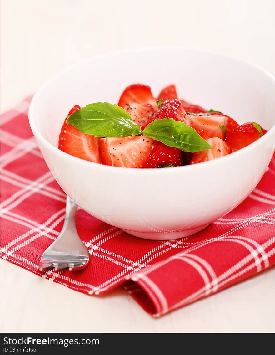 Fresh strawberry salad with basil and pepper