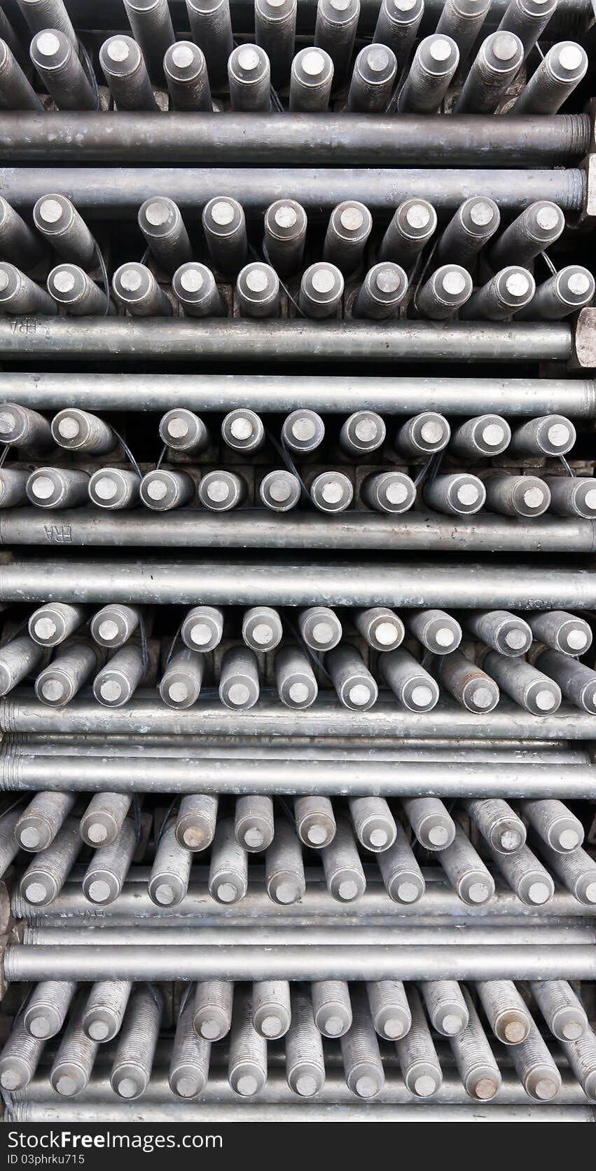 Many layers of machine bolts vertical