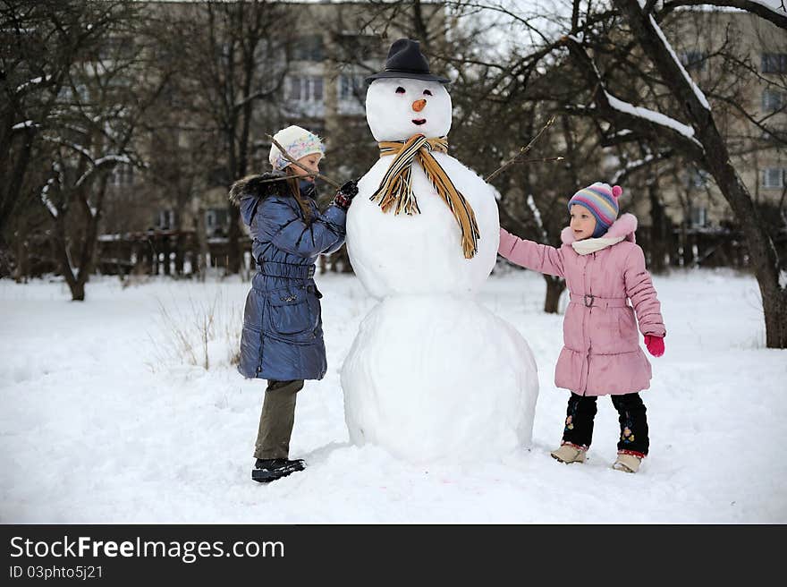 Two little girls are doing great snowmen. Two little girls are doing great snowmen