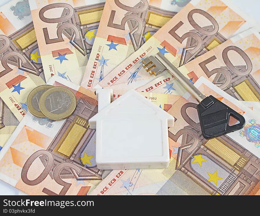 Fifty euro bills with coins to pay for a home. Fifty euro bills with coins to pay for a home