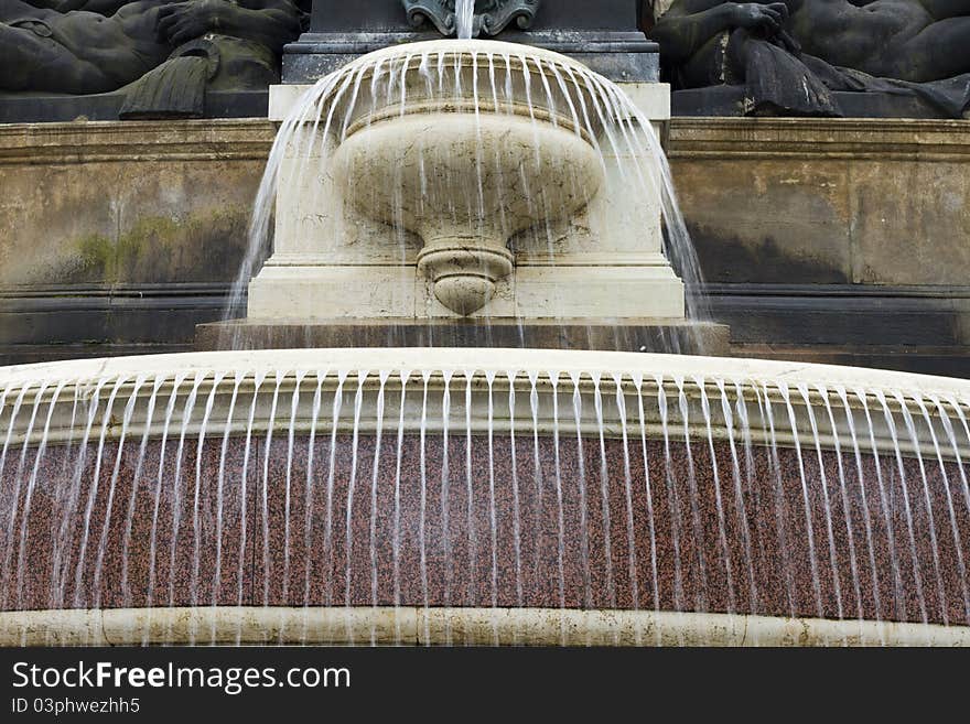 Fountain in flow with statues at the top