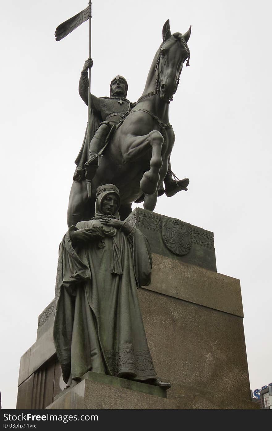 Statue man on a horse and woman standing