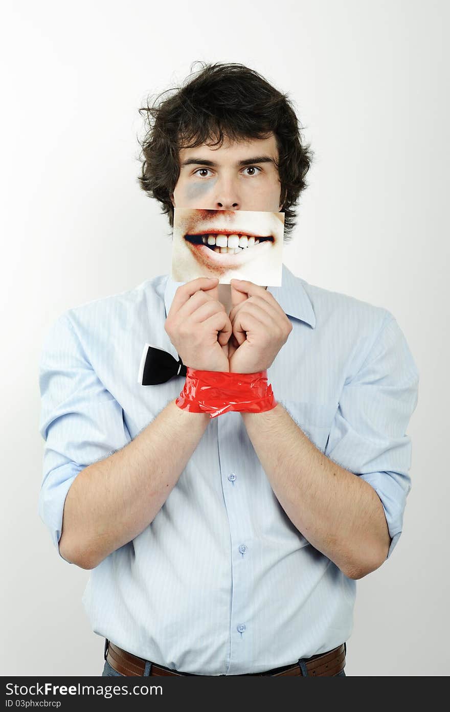 An image of a man with tape on his hands and a photo of a smile