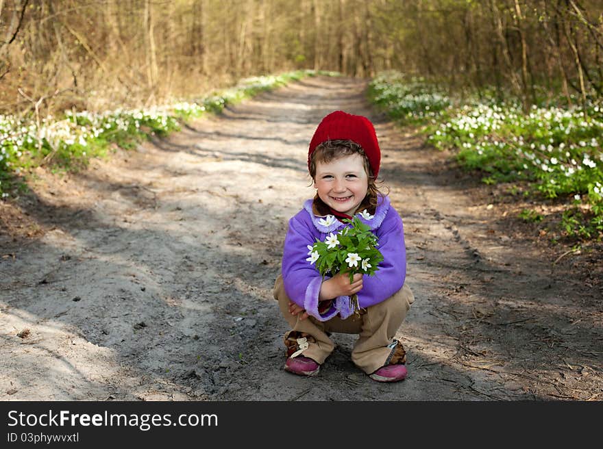 An image of a little girl in the forest