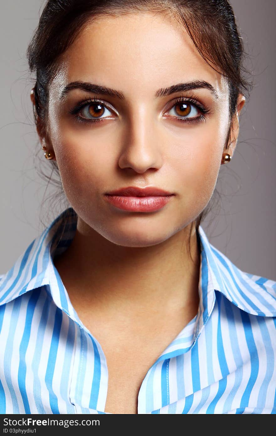 Young and beautiful woman in striped blouse