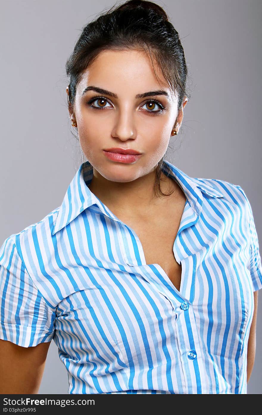 Young and beautiful woman in striped blouse