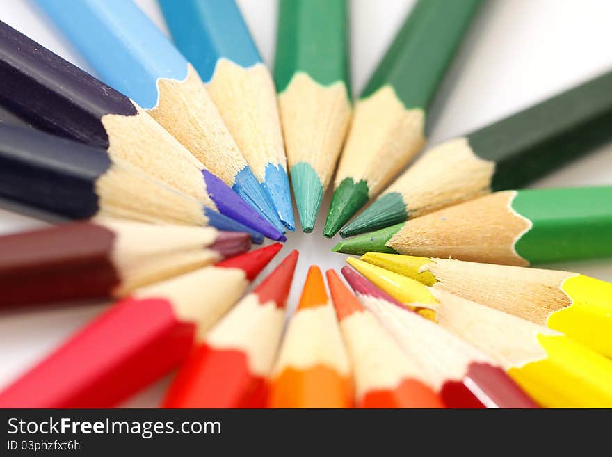 Color pencils in arrange in color wheel colors on white background. Color pencils in arrange in color wheel colors on white background