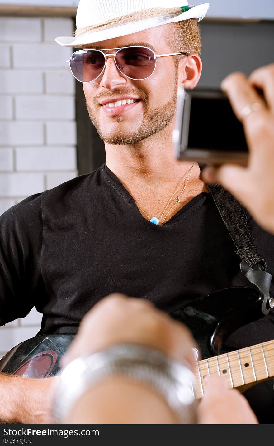 Selective focus on guitar player with fans around. Selective focus on guitar player with fans around.