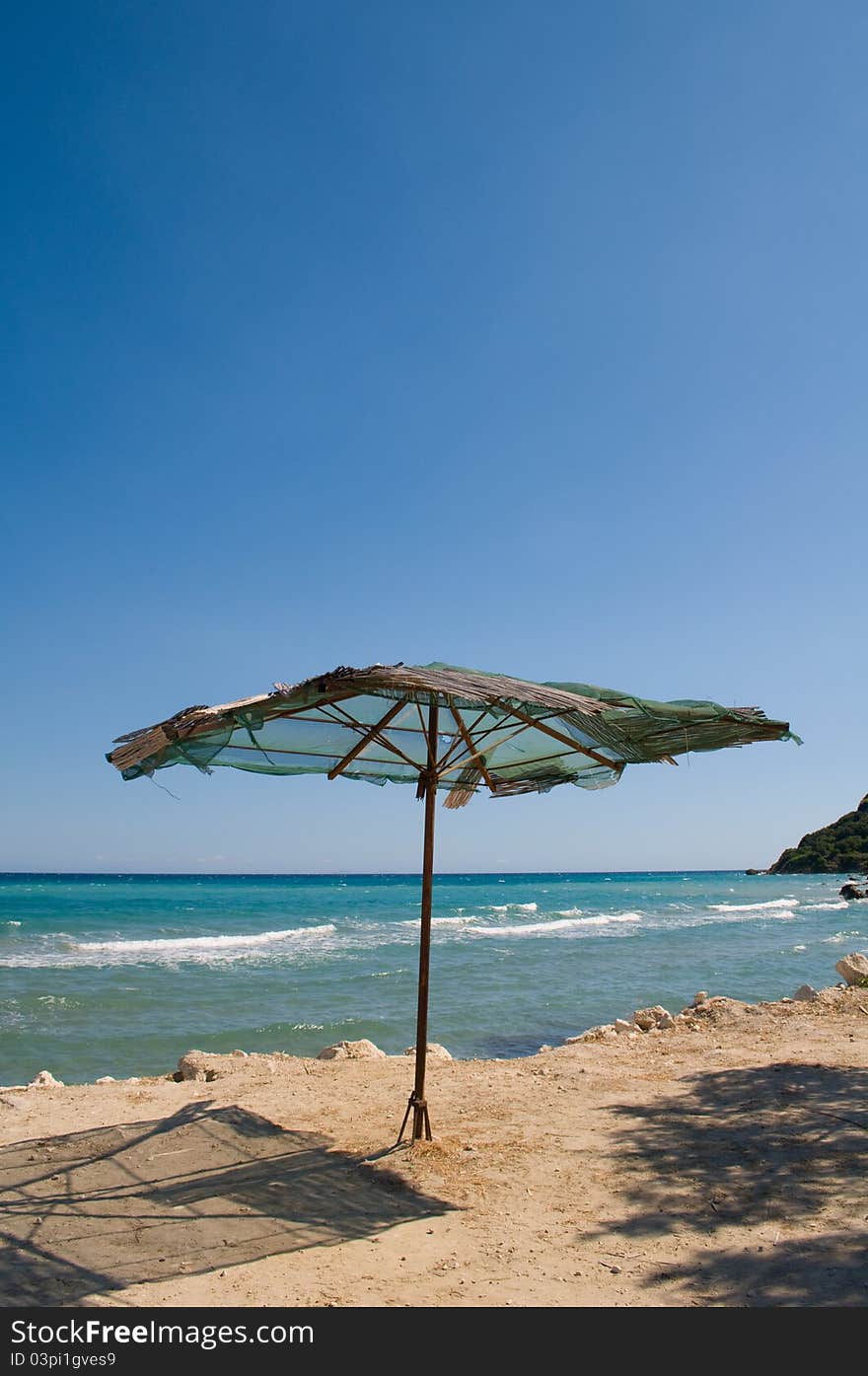 Rusty iron framed sun umbrella on beach. Rusty iron framed sun umbrella on beach