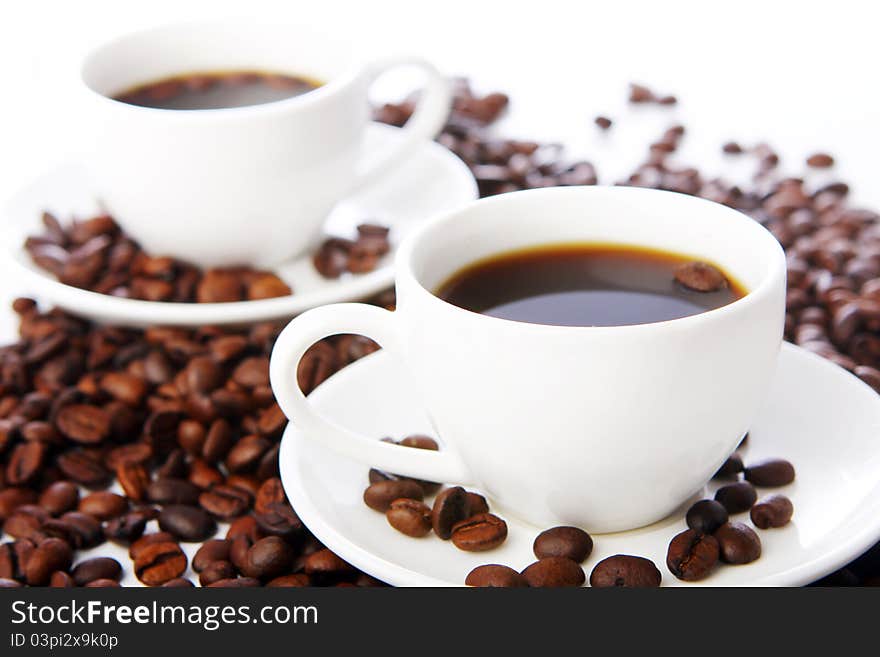 Coffee beans with white cups on the table