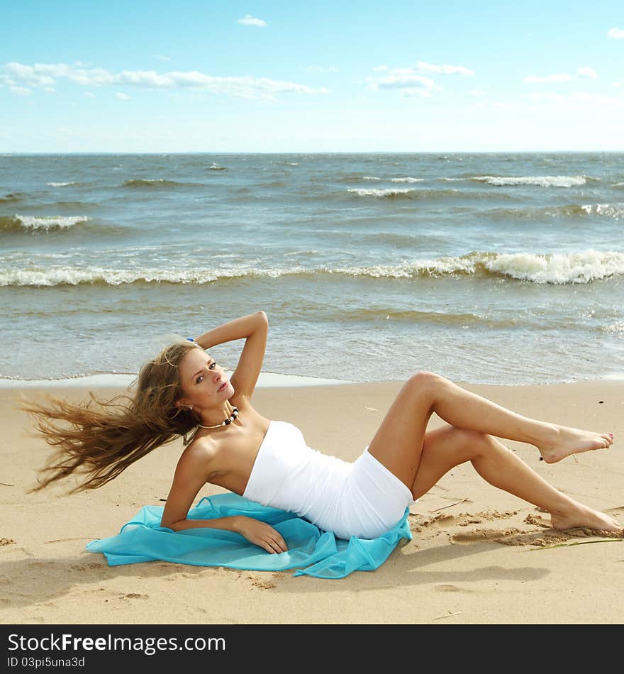 Woman laying on sand sea on background. Woman laying on sand sea on background