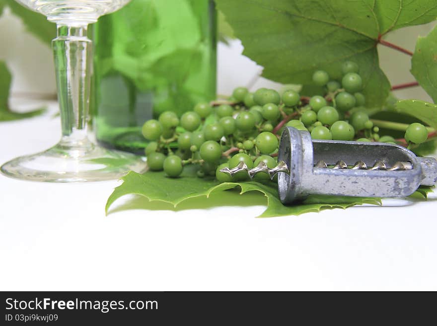 Wine cork, corkscrew and grapes with leaf on white background. Wine cork, corkscrew and grapes with leaf on white background