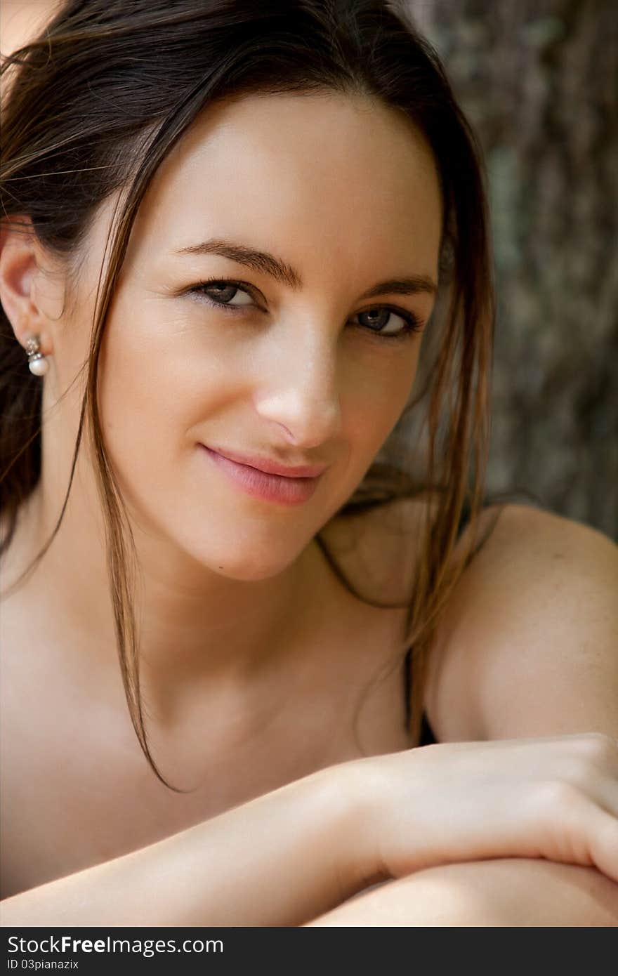 A healthy looking and beautiful young woman smiling at the camera. A healthy looking and beautiful young woman smiling at the camera.