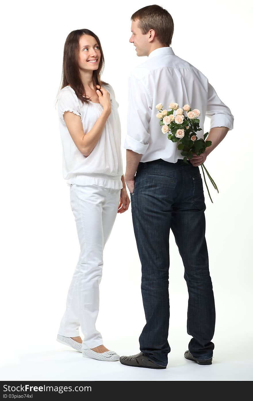 Romentic date: guy presenting flowers to young lady; white background