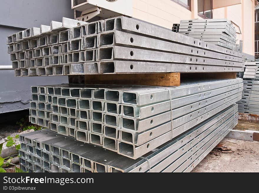 Pile of matal girder in group onfloor in stockpile tilted out. Pile of matal girder in group onfloor in stockpile tilted out