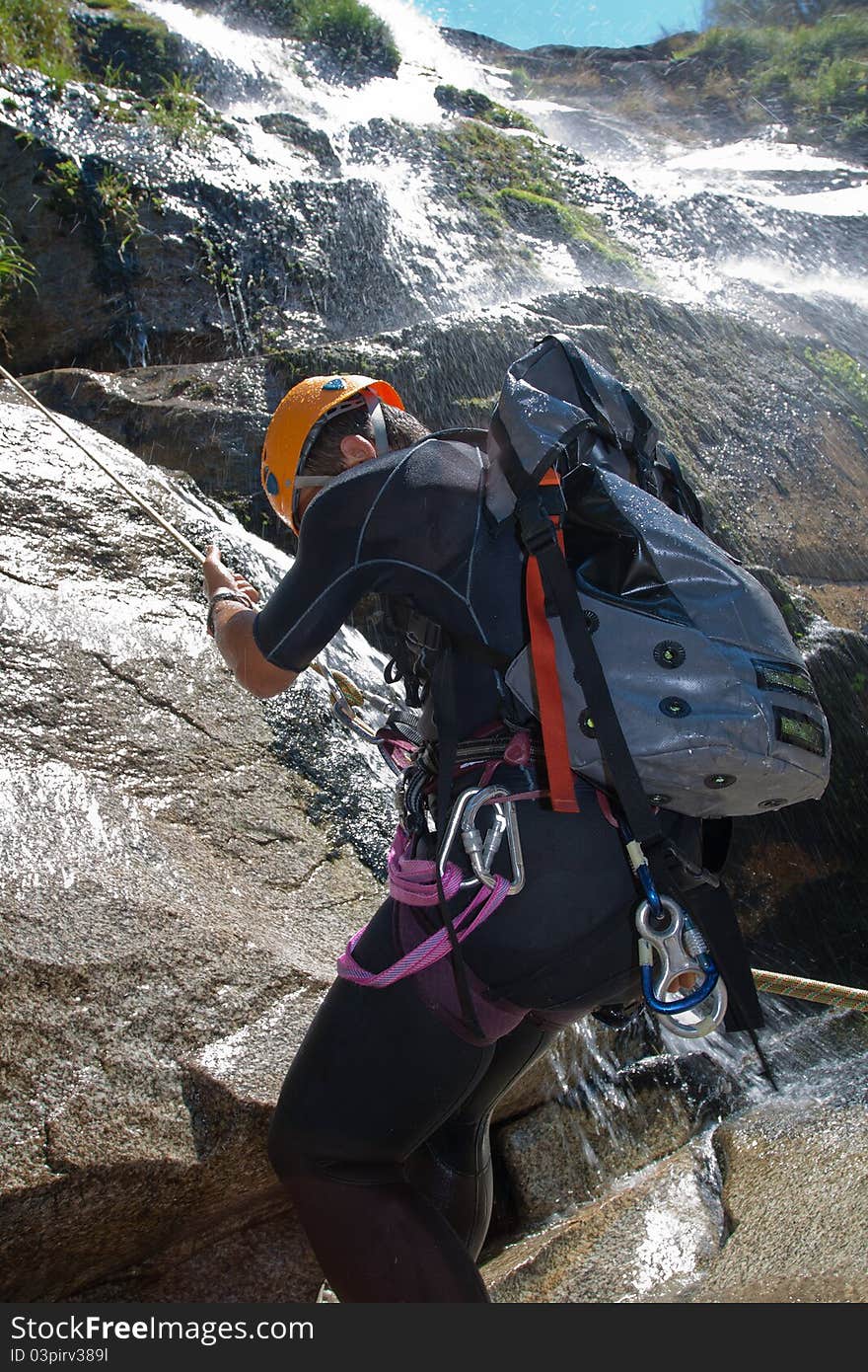 Men descending waterfall