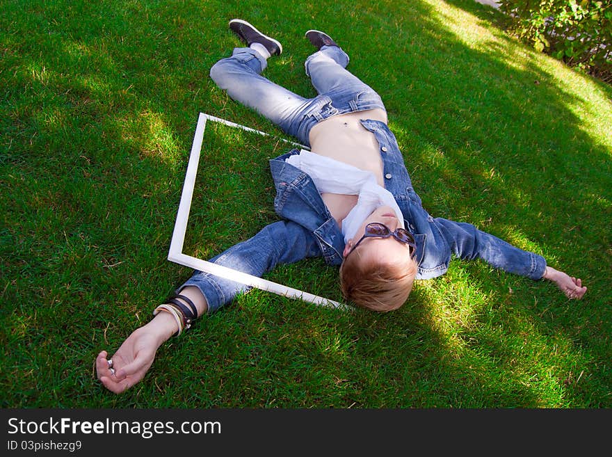 Young human on the green grass with white frame