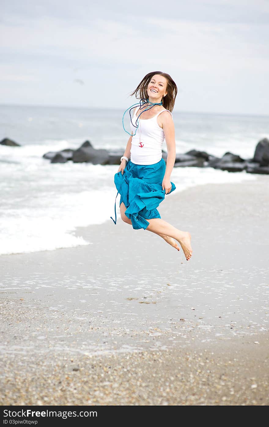 Beautiful Young Woman Has Fun On The Ocean Shore