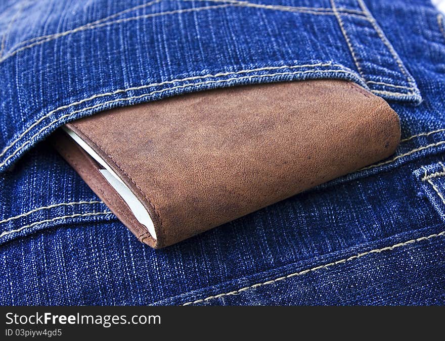 Leather Wallet With Money In Blue Jeans.