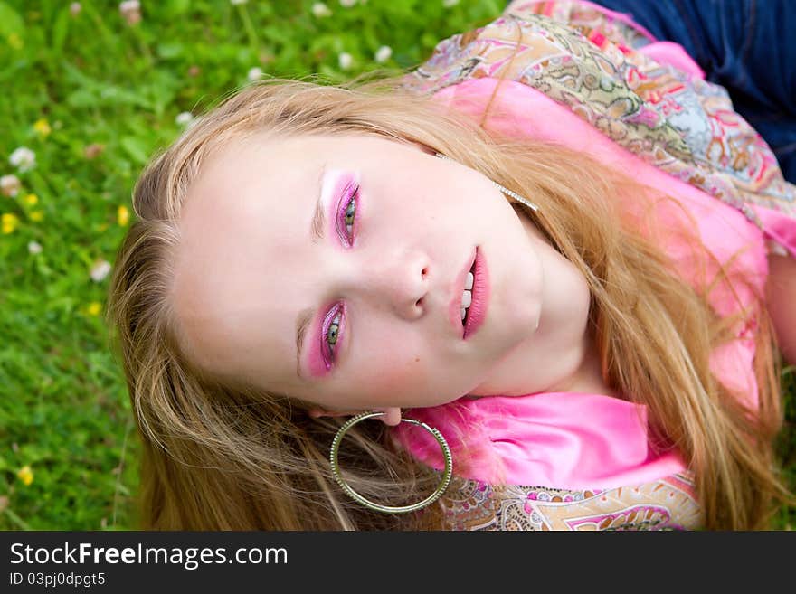 Portrait of a pretty girl in a meadow, a summer day