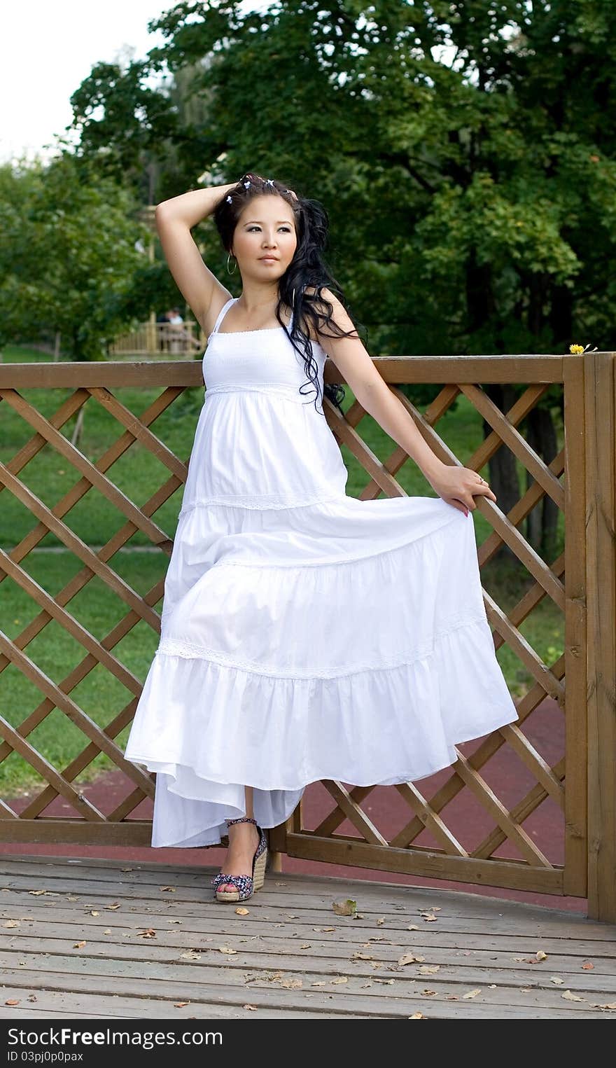 Beautiful pregnant girl walking in park in summer