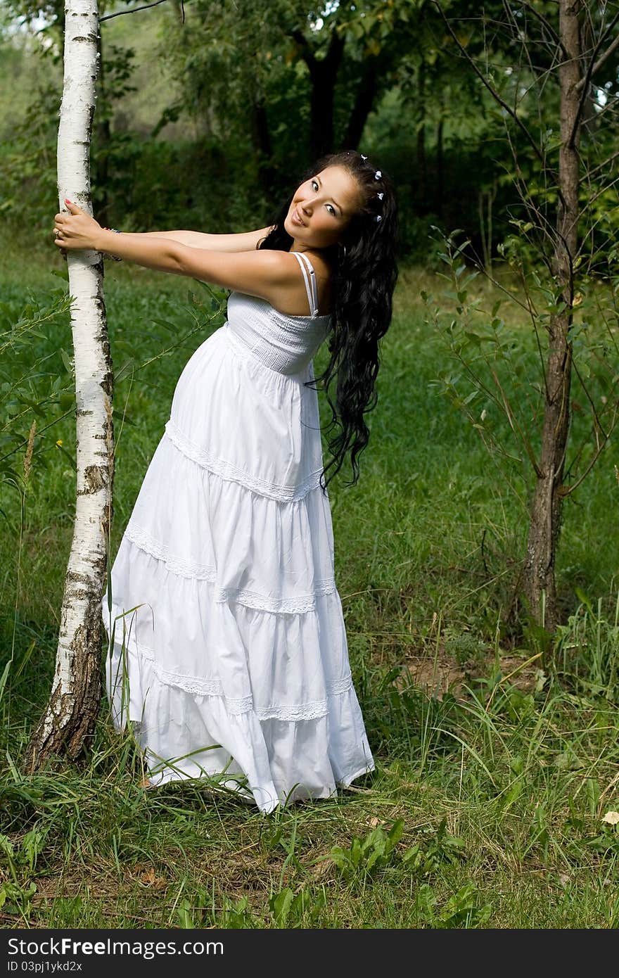 Beautiful pregnant girl walking in park