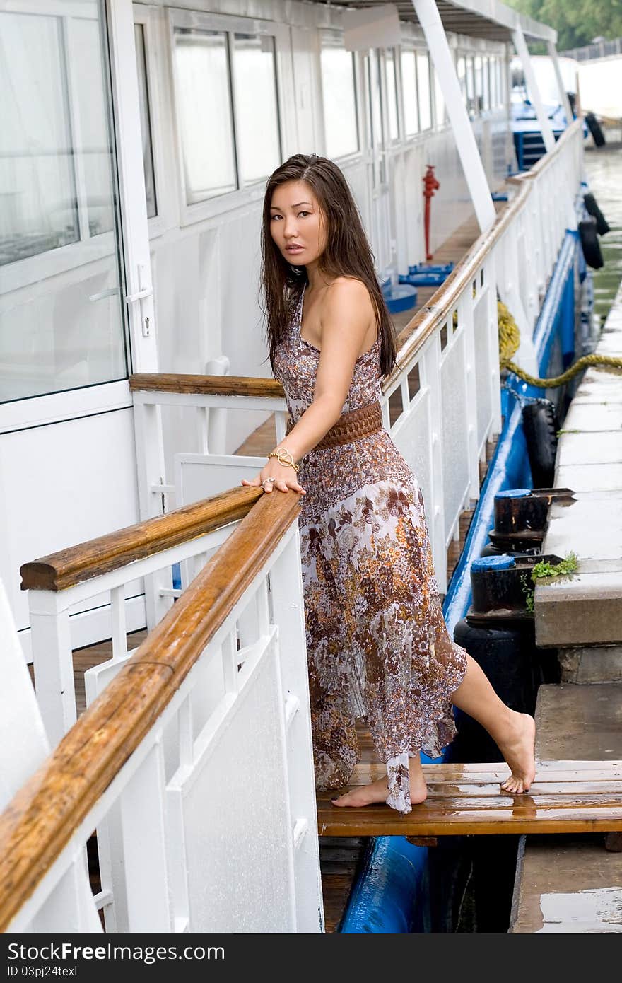 Beautiful girl walking near river on embankmant