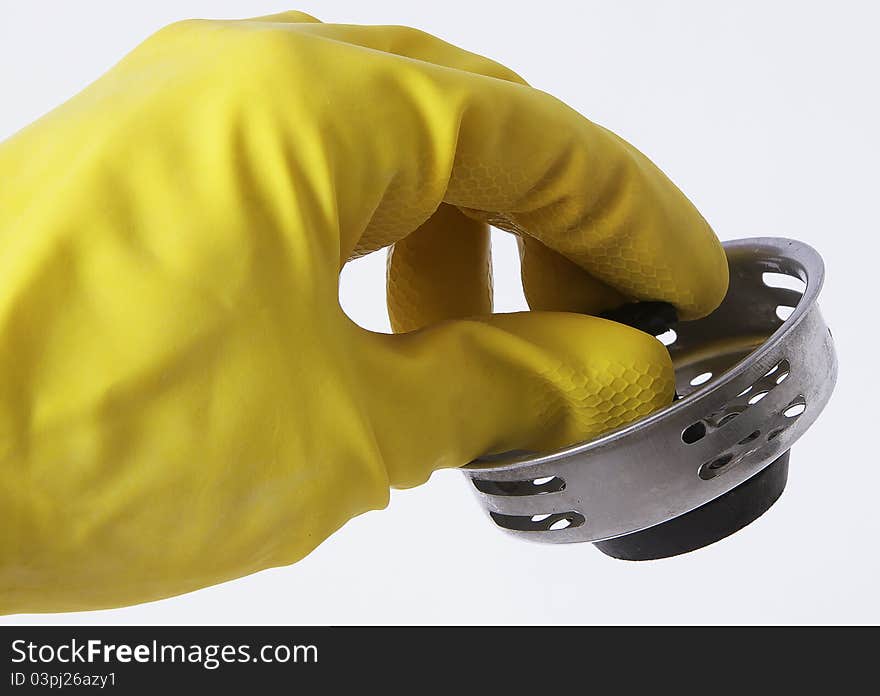 Yellow rubber glove holding a stopper for a sink. Yellow rubber glove holding a stopper for a sink.