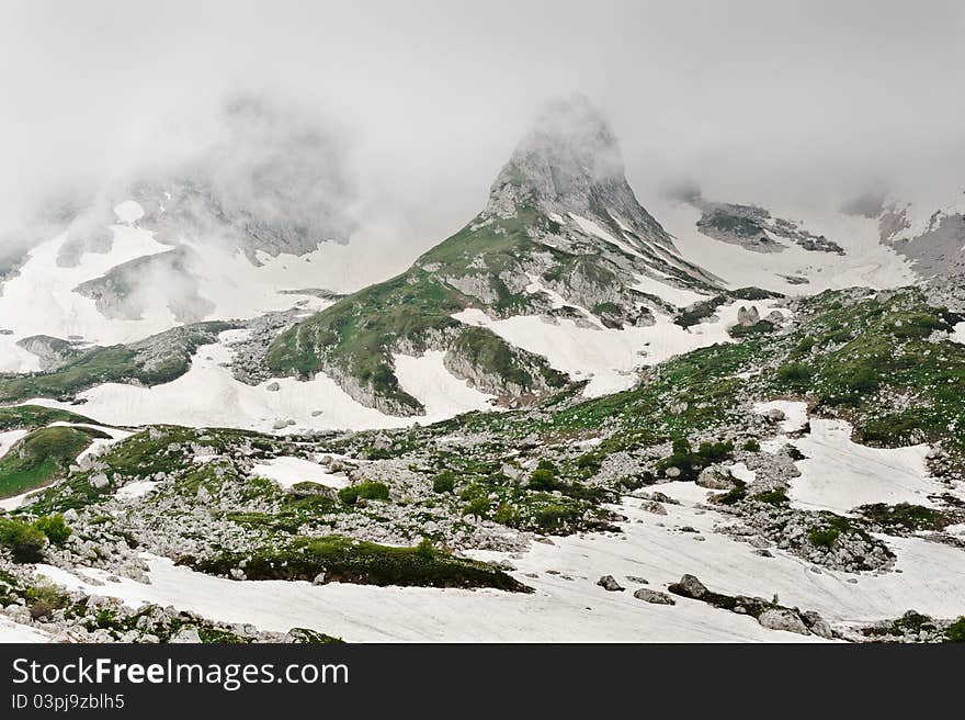 Snow and grass in the North Caucasus mountains. Russia.