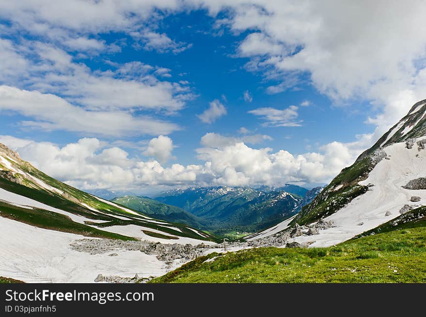 Snow and grass in the North Caucasus mountains. Russia.